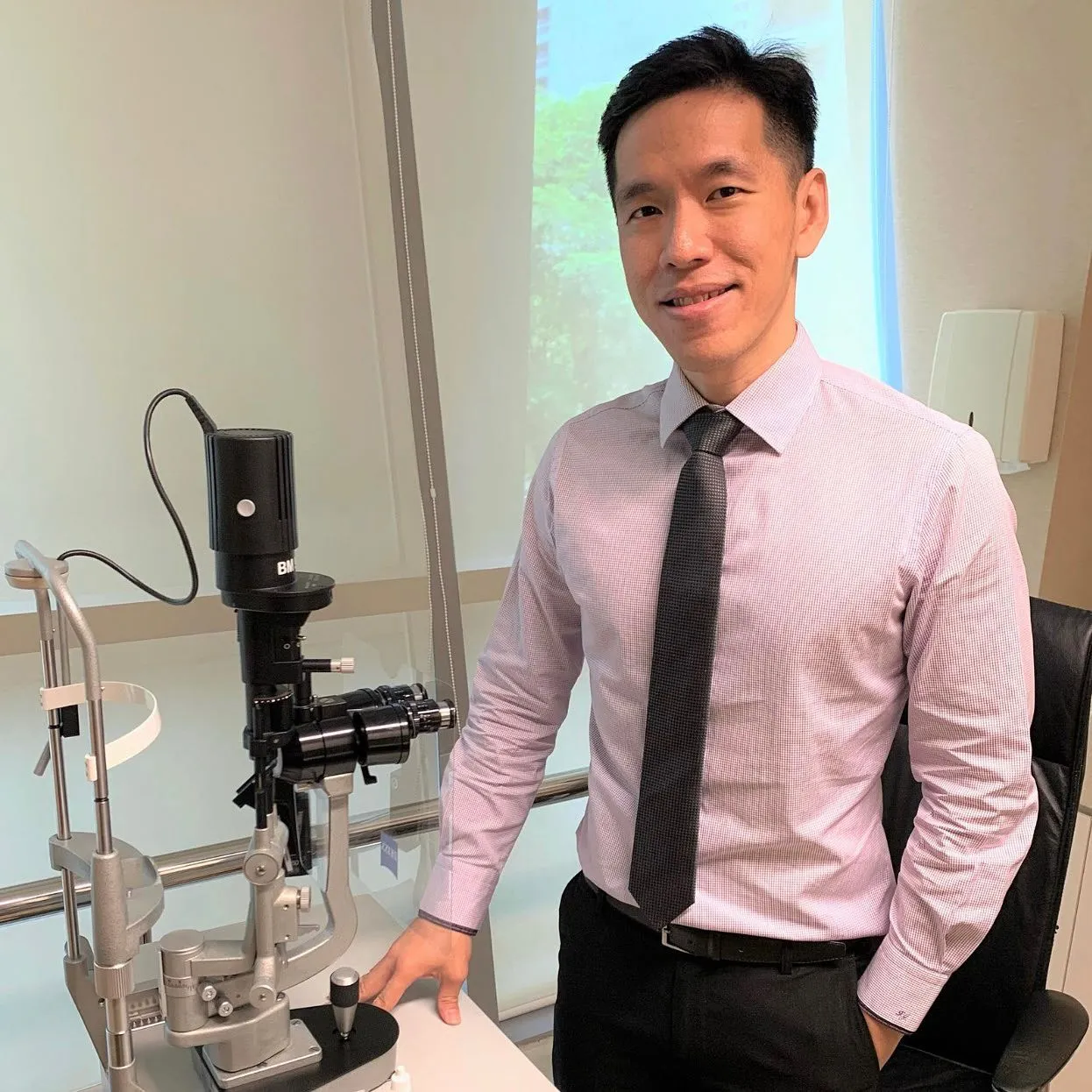 Dr Leslie Ang Pek Seng in eye clinic office