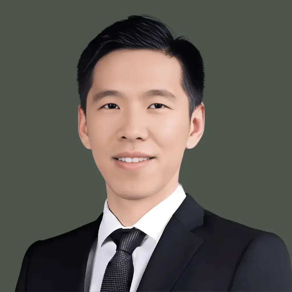 dr leslie ang in a black suite against a dark green background